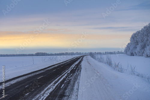 The road through winter fields on the expanses of Altai