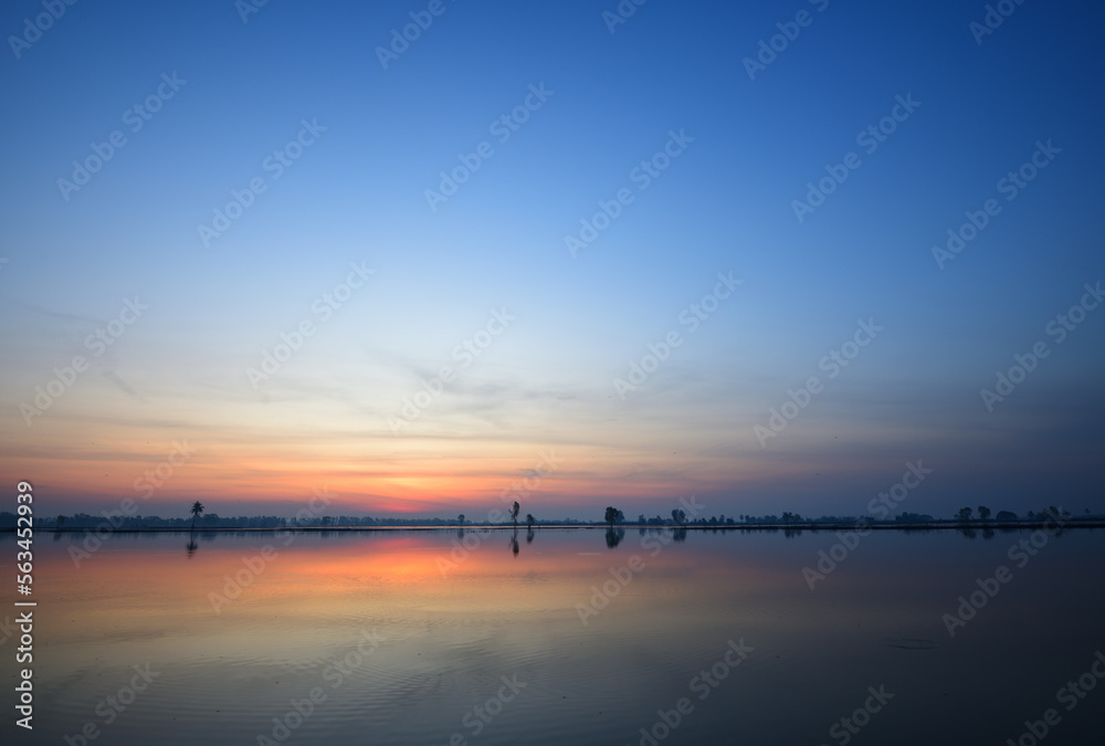 Panoramic view of dawn sky over the lake.