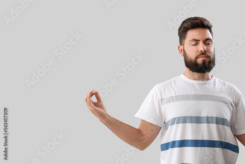 Handsome young man meditati...