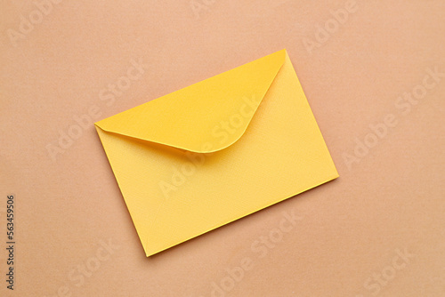 Yellow paper envelope on color background