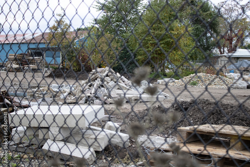 rubble behind the fence