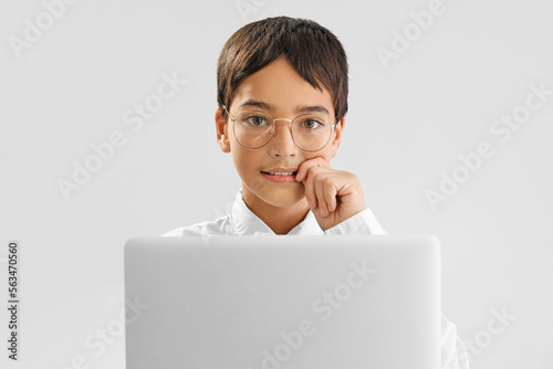 Young boy in glasses using ...