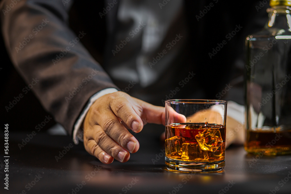 Closeup businessmen holding a glass of whiskey Closeup businessmen holding a glass of whiskey