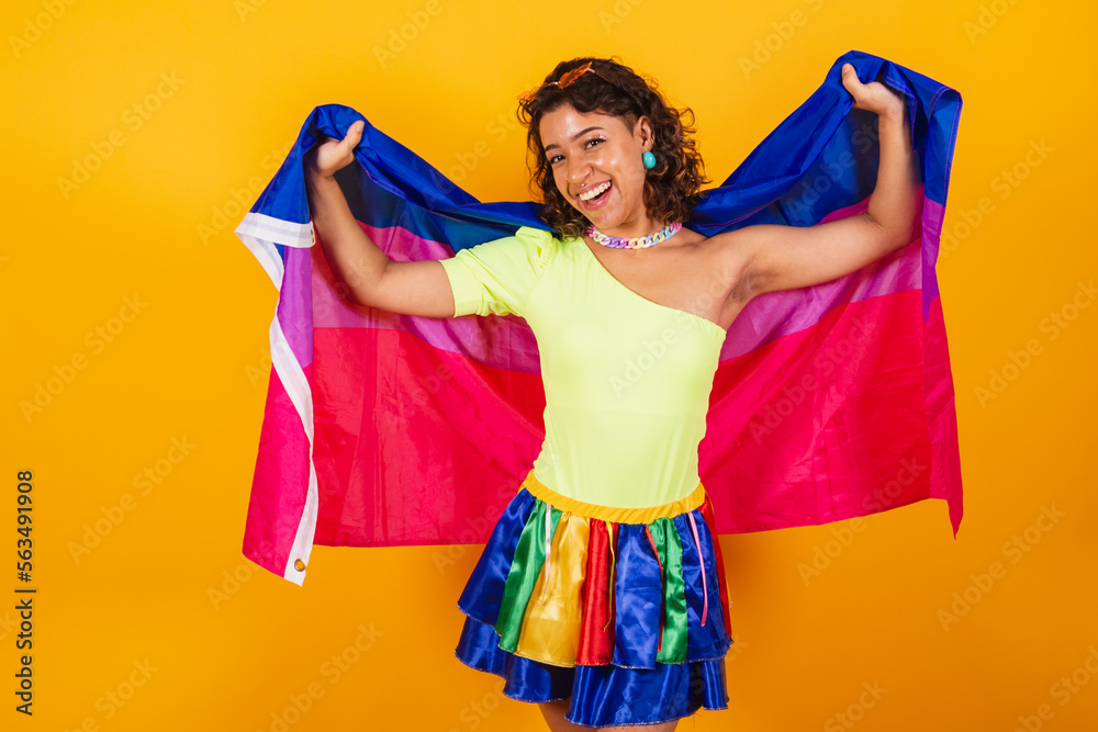 beautiful afro american brazilian woman in carnival clothes holding bisexual lgbt flag. Bisexual pride. - obrazy, fototapety, plakaty 
