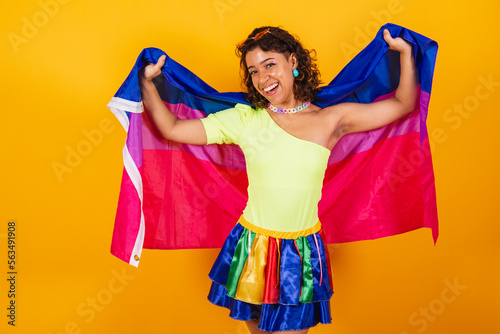 beautiful afro american brazilian woman in carnival clothes holding bisexual lgbt flag. Bisexual pride. photo
