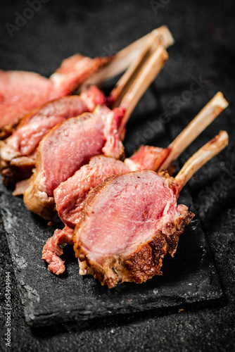 Rack lamb grill on a stone board. 