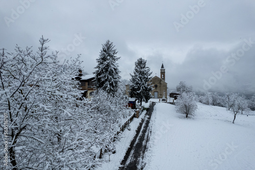 Winter snowstorm on Castelletto, Vernasca, Piacenza, Italy, covered with snow, drone aerial view photo