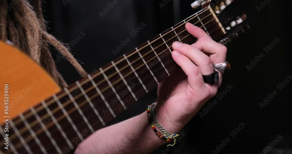 Guitarist man plays an acoustic guitar Close-up at studio Guitarist man plays an acoustic guitar Close-up at studio