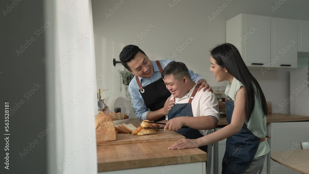 Happy Asian family enjoy cooking in the kitchen at home. Happy Asian family enjoy cooking in the kitchen at home.