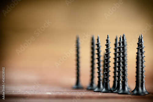 Self-tapping screw on wood on the table. 