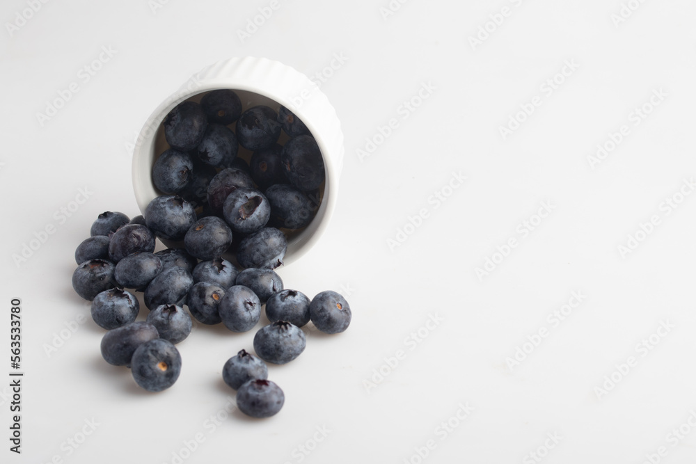 blueberries in a cup on a white background blueberries in a cup on a white background