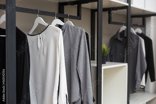 Modern wardrobe with stylish clothes in room interior