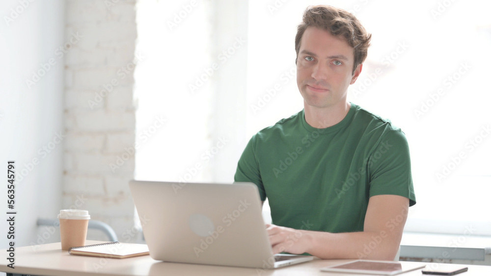 Man Shaking Head in Rejection While Working on Laptop Man Shaking Head in Rejection While Working on Laptop