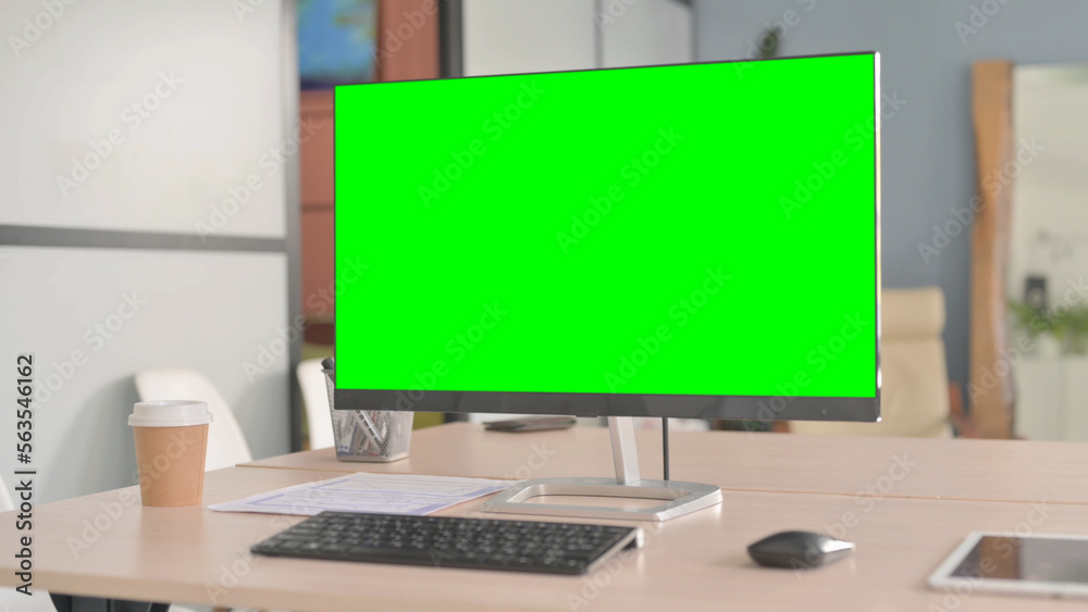 Desktop with Green Screen on Table in Office Desktop with Green Screen on Table in Office