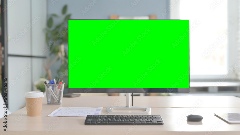 Desktop with Green Screen on Desk in Office Desktop with Green Screen on Desk in Office