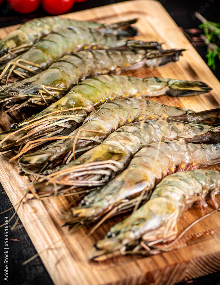 On a wooden cutting board raw shrimp. On a wooden cutting board raw shrimp.