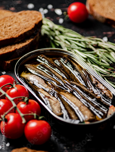 Sprats with cherry tomatoes on the table. 