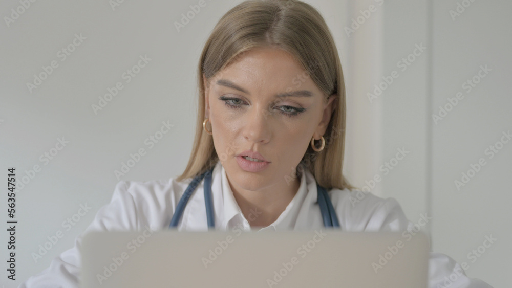 Close up of Female Doctor Talking on Video Call on Laptop in Clinic Close up of Female Doctor Talking on Video Call on Laptop in Clinic