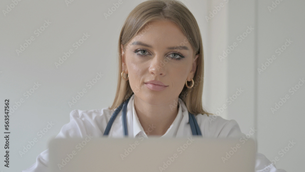 Close up of Female Doctor Shaking Head in Rejection while Working on Laptop in Clinic Close up of Female Doctor Shaking Head in Rejection while Working on Laptop in Clinic