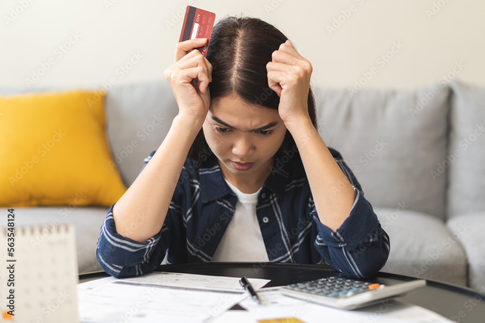 Business financial concept, owe asian young woman, female sitting cover face with hands, stressed by calculate expense from invoice or bill, have no money to pay mortgage or loan. Debt, bankruptcy. Business financial concept, owe asian young woman, female sitting cover face with hands, stressed by calculate expense from invoice or bill, have no money to pay mortgage or loan. Debt, bankruptcy.