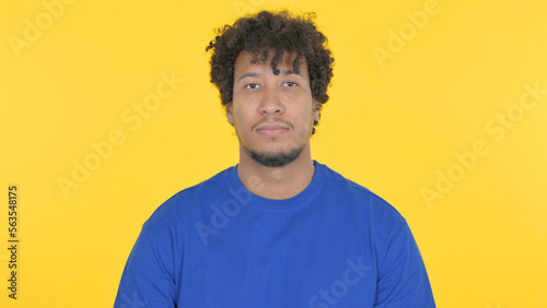 Serious African Man on Yellow Background
