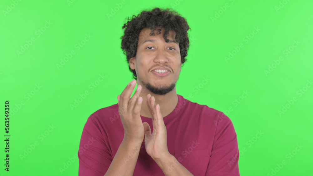 African Man Clapping on Green Background African Man Clapping on Green Background