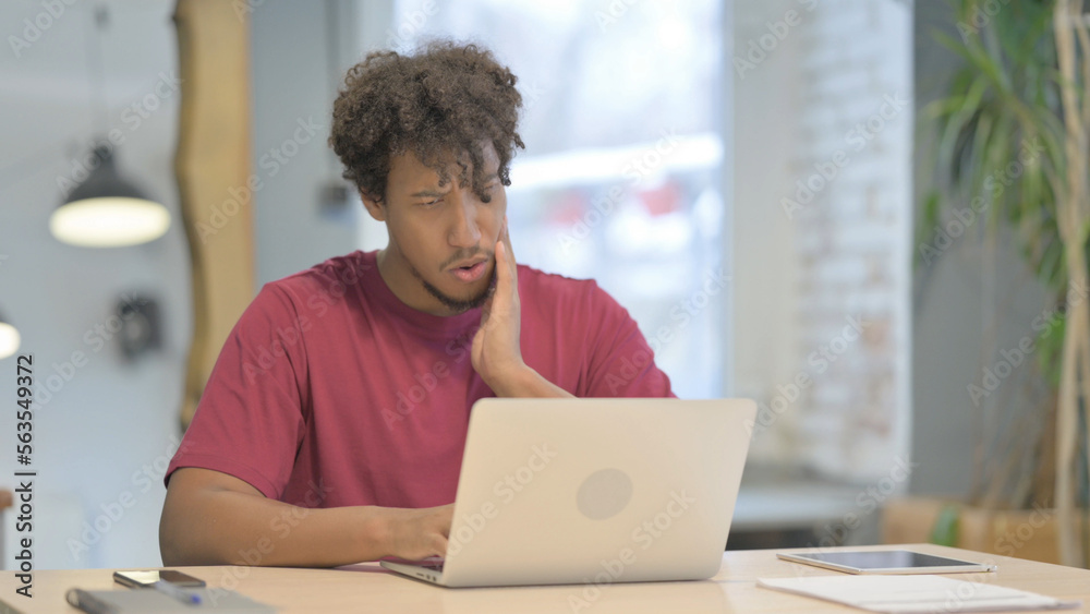 African Man having Toothache while Working on Laptop African Man having Toothache while Working on Laptop
