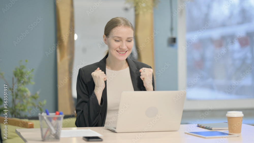 Businesswoman Celebrating Online Success on Laptop in Office Businesswoman Celebrating Online Success on Laptop in Office