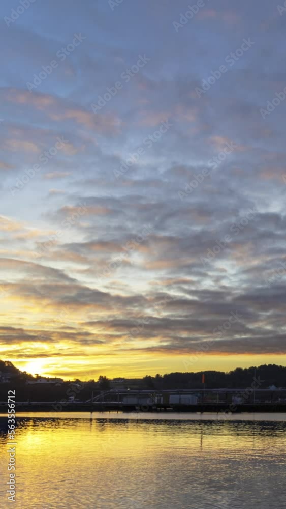 Vertical timelapse sunset clouds over the sea