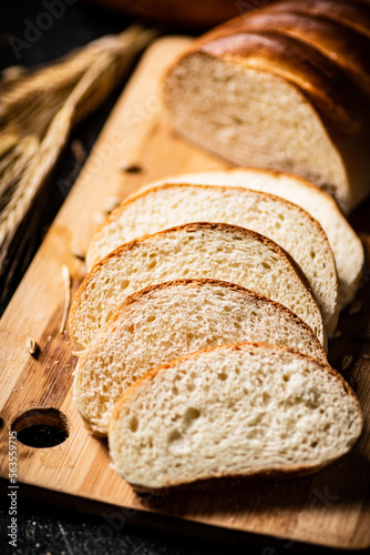 Sliced fresh wheat bread on a cutting board. 