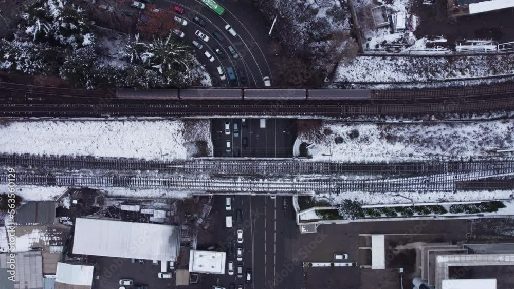 Trains cross the bridge above the highway