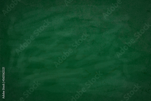 Green chalkboard texture for school display backdrop. Chalk traces erased with graphic design grunge background. Dark green board. Education concepts.
