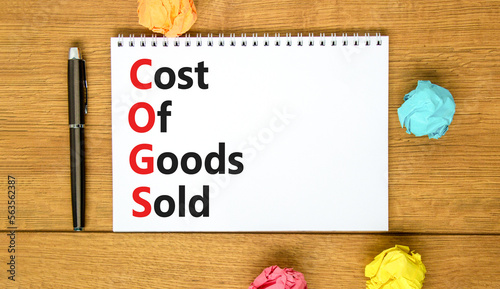 COGS cost of goods sold symbol. Concept words COGS cost of goods sold on white note on beautiful wooden background. Business COGS cost of goods sold concept. Copy space. © Dzmitry