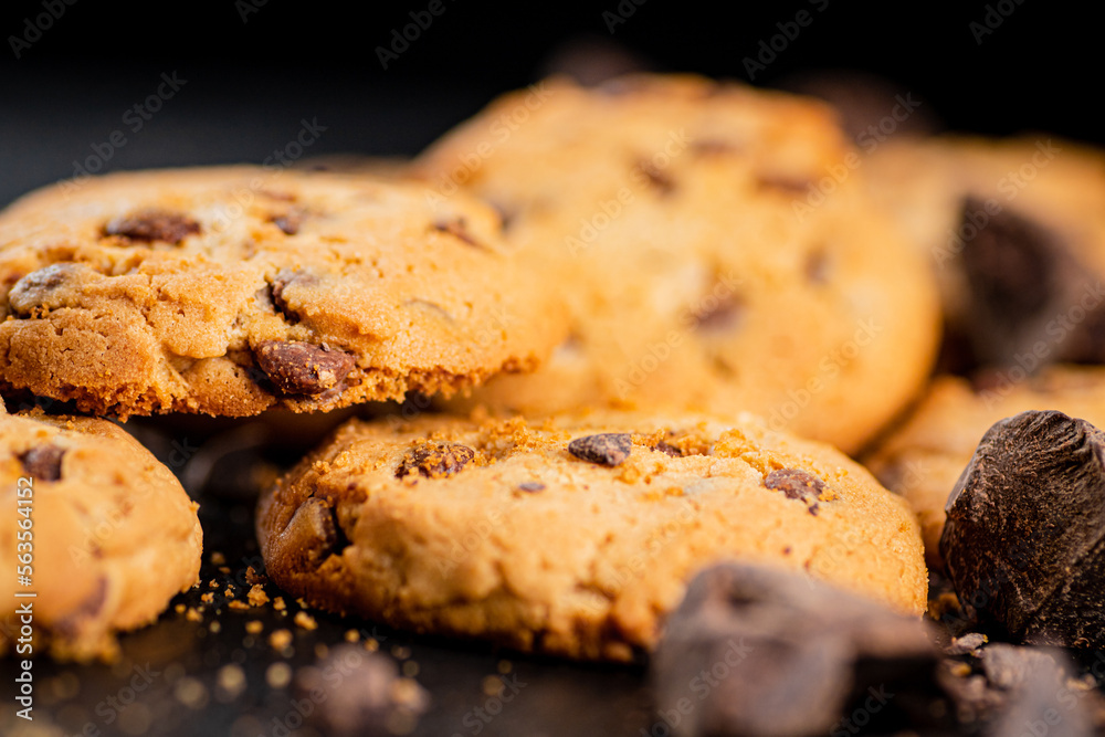 Cookies with pieces of milk chocolate on a stone board. Cookies with pieces of milk chocolate on a stone board.