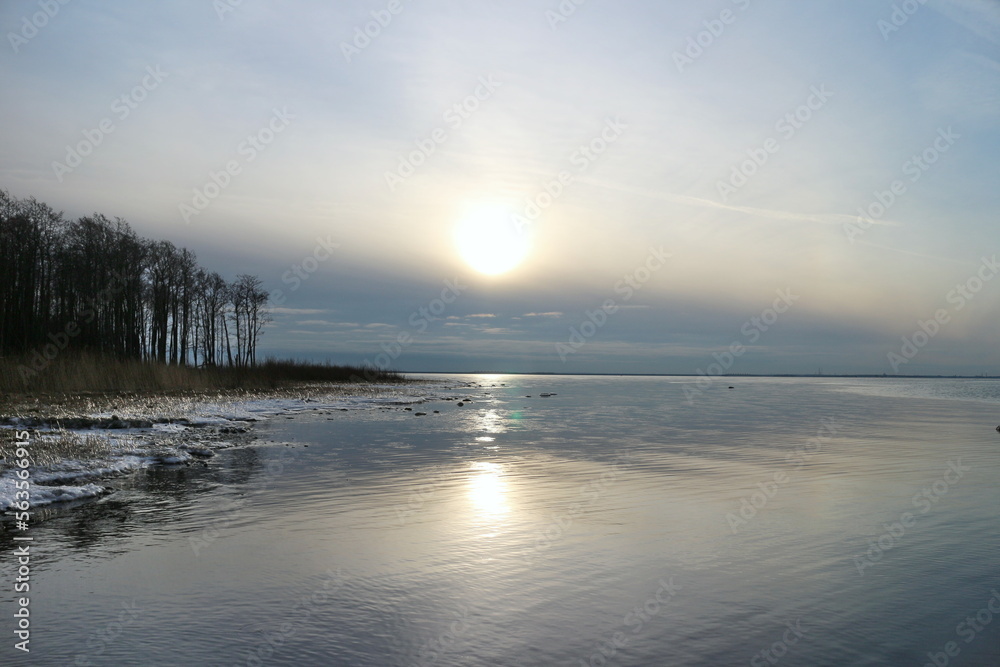 cold winter sun hangs low over the horizon, seascape cold winter sun hangs low over the horizon, seascape