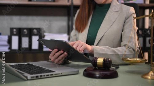 justice and law concept.Male judge in a courtroom  the gavel, working with smart phone and laptop and digital tablet computer on wood table in morning light