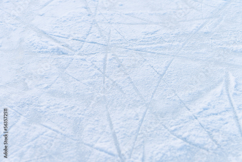 ice texture close up. Skating rink covered with snow. Skate tracks in the snow