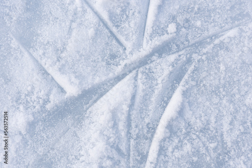 ice texture close up. Skating rink covered with snow. Skate tracks in the snow photo