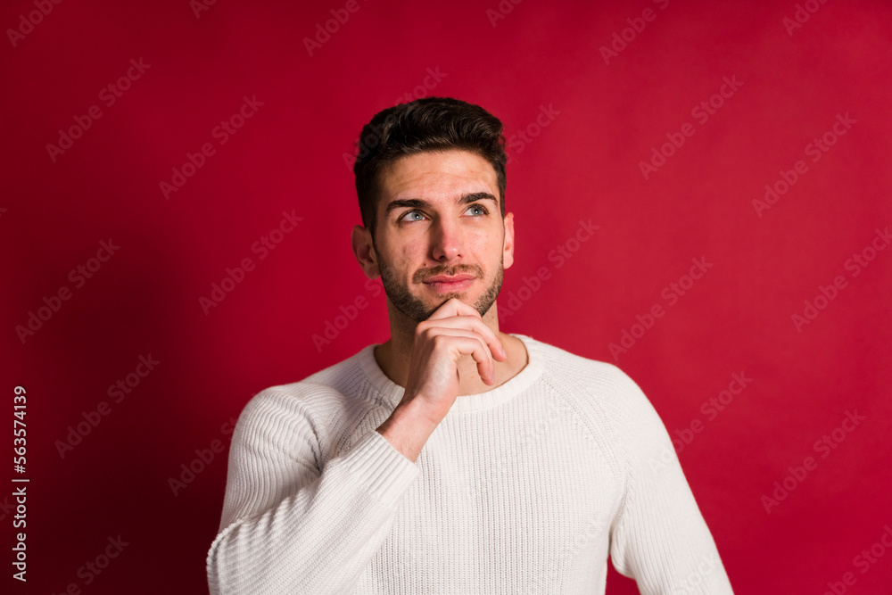 Thoughtful man touching chin and looking at camera Thoughtful man touching chin and looking at camera