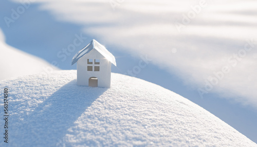 Decorative white house with a spruce tree in the snow in the sunlight outdoors, free space