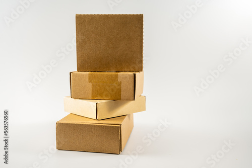 stack of new cardboard  mailling storage boxes ready for recycling into new products isolated on white background photo