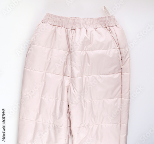 insulated winter pink pants on a white background.  © andrey