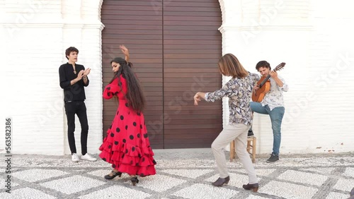 Multiethnic group of flamenco dancers dancing for tourists in San Nicolas. Albaicin. photo