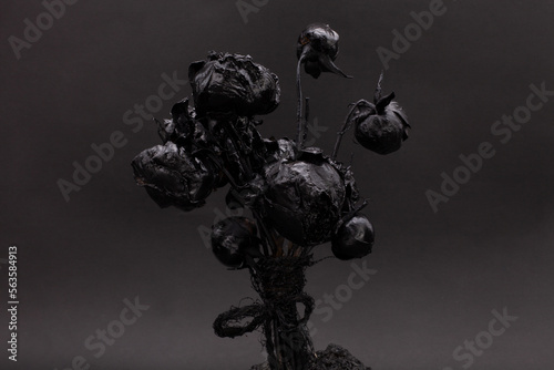 Black gothic bouquet on a black background. Black on black. Dark beauty. Beautiful flowers. Monochrome image.