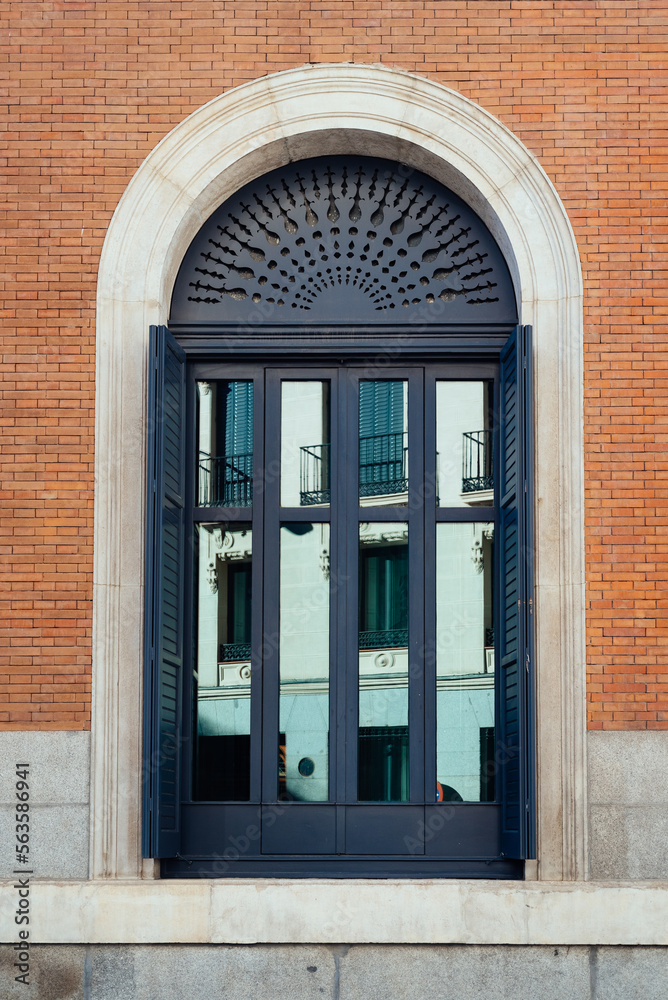 Obraz premium Classic door with arch in brick facade of luxury building. Exterior viewe