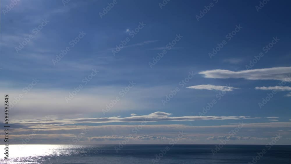Clouds float over the sea and the sun is reflected in the water Clouds float over the sea and the sun is reflected in the water