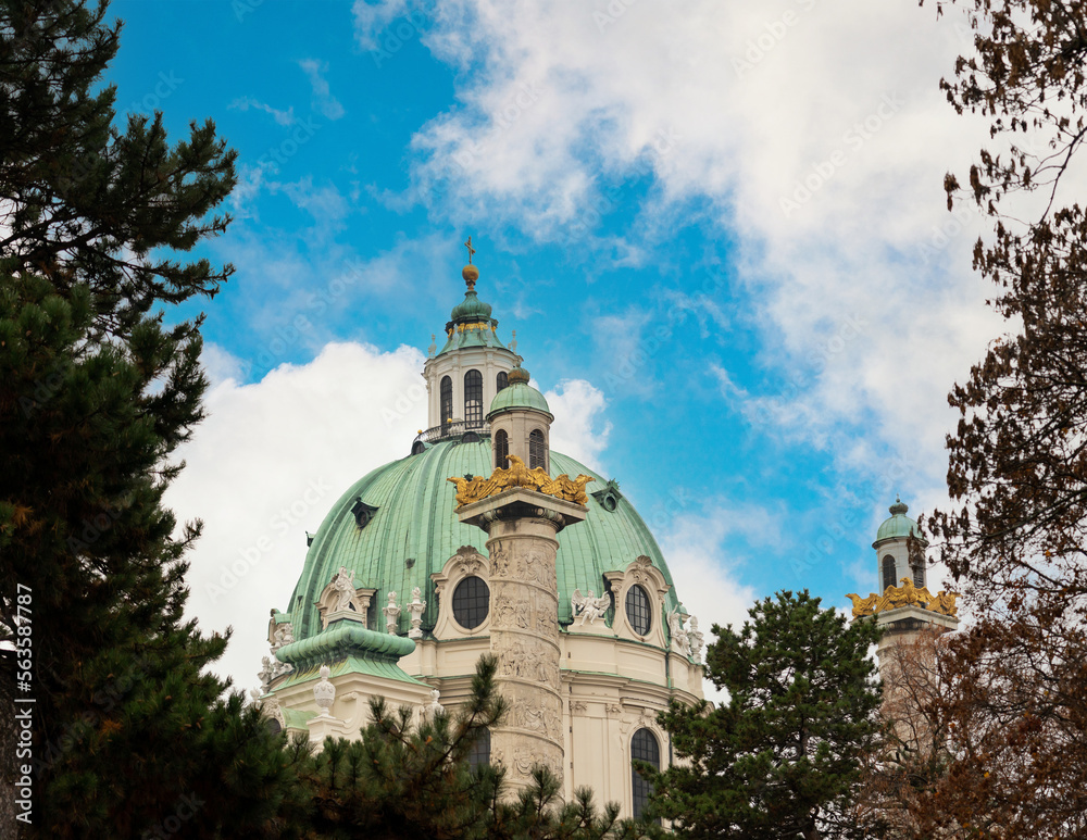 Domes and columns of the Karlskirche church in Vienna against the backdrop of blue clouds