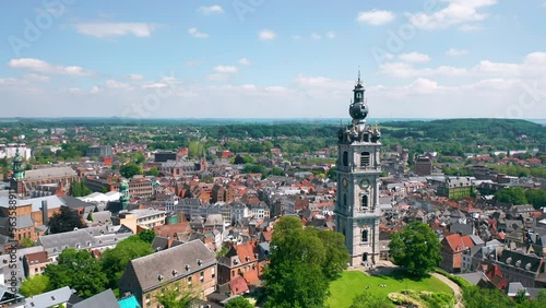 Aerial summer skyline panorama of the old town of Mons (Bergen). The Belfry of Mons (Beffroi de Mons) in the foreground. Wallonia, capital of Hainaut, Belgium. 