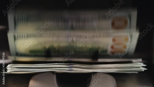 USD dollars cash deposit machine. Close up of currency counting machine counting new dollar bills. Machine counter automatic calculates a large amount of Dollar banknotes in 4k Slow motion 100fps