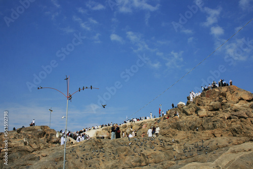 Pilgrims praying and visiting the Mount Arafat Jabal al-Rahmah in Hejaz, Saudi Arabia. photo